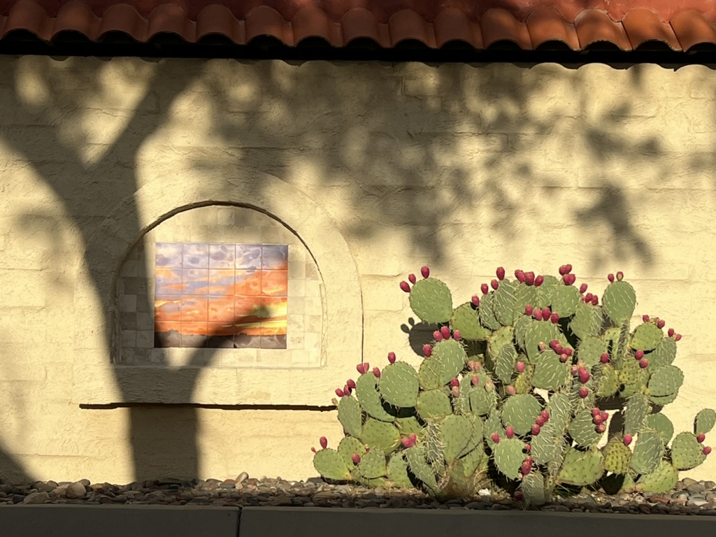 prickly pear and tile mural in exterior decorative arch after sunrise, Green Valley, Arizona